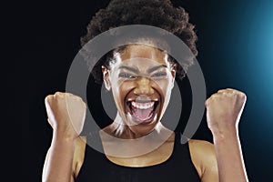 Im a born winner. Studio shot of a young sportswoman posing with her fists clinched against a dark background. photo