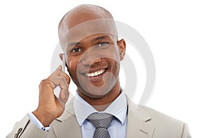 Im always on call. A young AfricanAmerican businessman speaking on his cellphone. photo