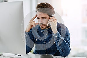 Im calling for the tenth time now... a handsome young businessman looking frustrated while making a phonecall in his