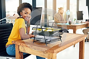 Im confident about succeeding in this business. Portrait of a young businesswoman sitting in an office with colleagues