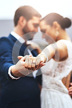 Im dancing into forever with you. a happy newlywed young couple holding hands and dancing together on their wedding day.