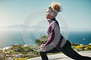 Im doing this for me. a young woman stretching outdoors before her run.