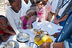 Im either happy or hungry. Cropped portrait of children getting fed at a food outreach.