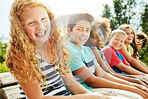 Im excited for a day of fun with my buddies. Portrait of a group of diverse and happy kids hanging out together outside.