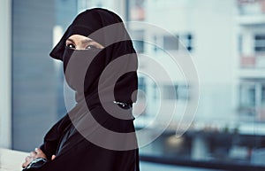 Im in get it done mode. Cropped portrait of an arabic businesswoman in a burka standing in her office.