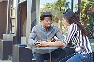 Im glad you asked me out for coffee. a young couple on a coffee date at a sidewalk cafe.