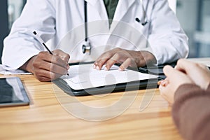 Im going to have to give you something stronger. an unrecognizable doctor sitting with his patient and writing a