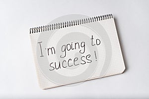Im going to success, inscription in notebook. White background