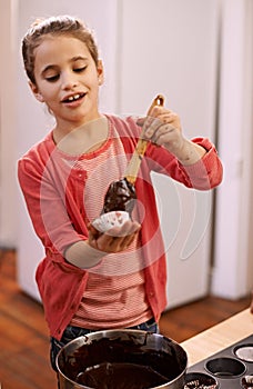 Im going to surprise mom with these...A little girl having fun learning how to bake.