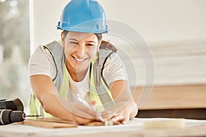 Im happy with these measurements. Shot of an attractive young construction worker standing alone and using a ruler to