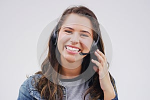 Im always happy to help. Studio portrait of an attractive young female customer service representative wearing a headset