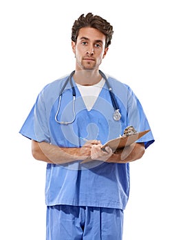 Im here to help. Studio portrait of a handsome young medical professional holding a clipboard.