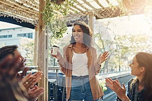 Im so humbled...an attractive young businesswoman addressing her colleagues during a breakfast meeting outside.