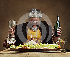 Im the life of the party. A mature king feasting alone in a banquet hall.