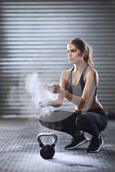 Im making myself hot. a sporty young woman dusting her hands with talcum powder.