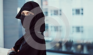 Im making this workplace my own. Cropped portrait of an arabic businesswoman in a burka standing in her office.