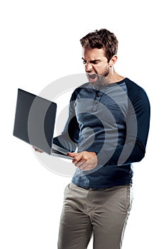 Im never using this internet provider again. Studio shot of a handsome young man using a laptop and looking stressed