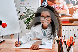 Im always ready to do a quick quiz test. Portrait of an adorable young school girl writing notes in her note book in