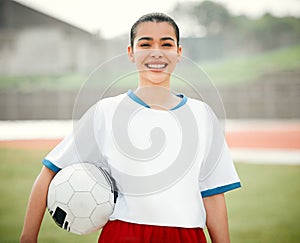 Im ready to kick it. Cropped portrait of an attractive young female footballer standing outside with a soccer ball in