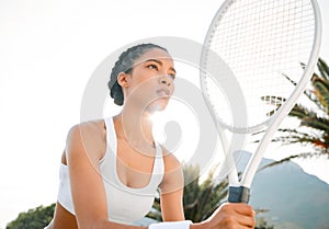 Im ready to win this. a sporty young woman playing tennis on a court.