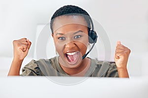 Im on a roll today. Shot of a businesswoman looking cheerful while working in a call centre.