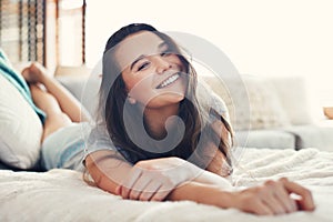 Im smiling because Im comfortable. Portrait of an attractive young woman spending a relaxing day on her bed at home.