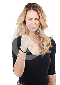 Im strong enough. Studio shot of a young woman holding up her fist against a white.