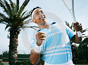 Im sure I can make it. Shot of a handsome young man getting ready to serve a ball during a tennis match.