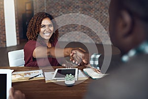 Im thrilled to be working with you. businesspeople shaking hands during a meeting in an office.