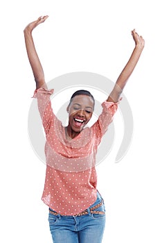 Im the winner. Studio shot of a young woman with arms raised in celebration.