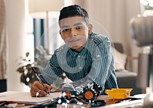 Im working towards becoming an engineer when I grow up. Portrait of a handsome young boy doing his homework on robotics