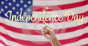 Image of 4th of july independence day text over sparkler and flag of united states of america