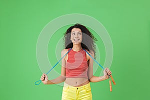 Image of active woman 20s wearing summer clothes working out and doing exercises with jumping rope