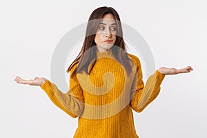 Image of adult woman wearing sweater hesitating and throwing up hands