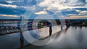 Aerial LGBTQ rainbow pride colors on bridge over Ohio River at sunset Kentucky