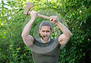 image of aggressive man with axe. aggressive man with axe. aggressive man with axe wearing shirt.