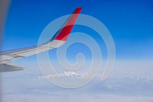 Image through aircraft window onto wing. Top view over Turkey to Erciyes volcano