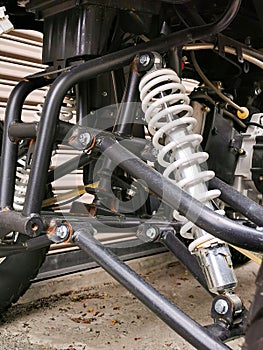 Image of all terrain vehicle absorber and coil spring. Selective focus.