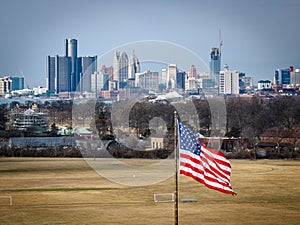 An image of the American flag with the Motor city skyline in the background. The definition of made in America