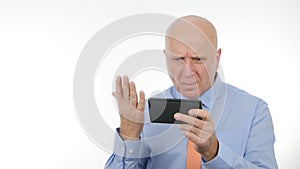 Image with Angry Businessman Reading Astonished Financial Bad News on Cellphone