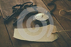 Image of antique keys, empty canvas tag and pocket clock