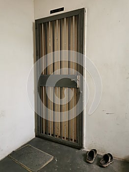 Image of apartment front door with grill.