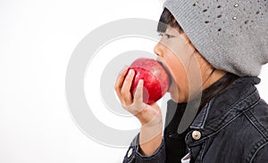 The image of an Asian girl eating a red  apple in his hand is healthy and good for a white background