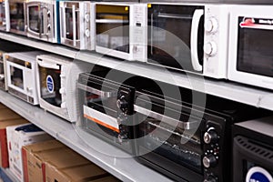 Image of assortment of a kitchen electric microwaves at store