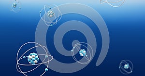 Image of atom models spinning on blue background
