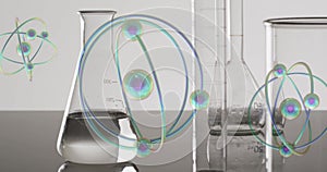 Image of atoms moving over laboratory dishes on grey background