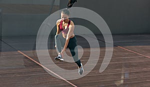 Image of an attractive athlete young girl relaxing after exercises with fit ball at the gym. Fit female resting on a medicine ball