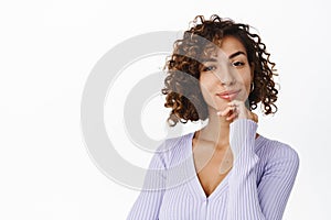 Image of attractive woman, girl with curly hairstyle, smiling and looking happy, has no blemishes on facial skin, clear