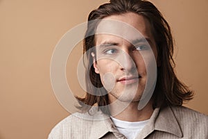 Image of attractive young man with red hair posing and looking aside