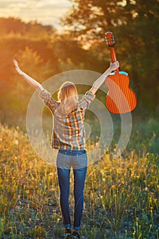 Image from the back of a happy young woman on the plaid shirt and blue jeans.